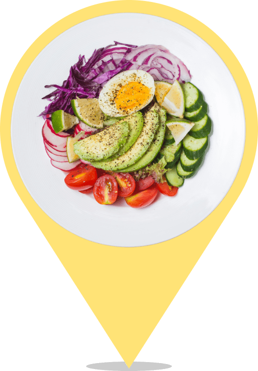 A plate of food with an egg, avocado and some vegetables.